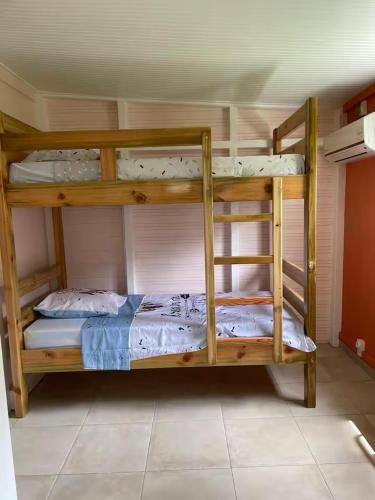a couple of bunk beds in a room at Gites vallée des caraibes in Bouillante