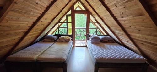 a room with three benches in a attic with windows at Beržoro pakrantė in Berżory