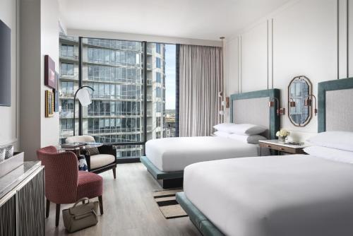a hotel room with two beds and a desk at Hyatt Centric Downtown Nashville in Nashville
