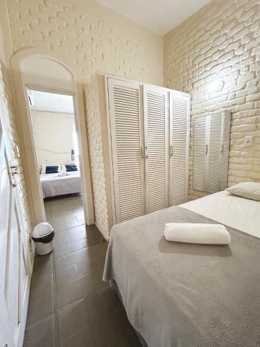 a bedroom with a bed with a towel on it at Pousada Nossa Natal in Natal
