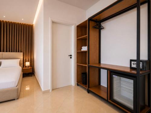 a bedroom with a bed and a tv in a room at Dine Hotel in Ksamil
