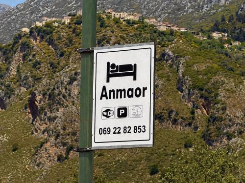 a sign on a pole in front of a mountain at Anmaor in Qeparo