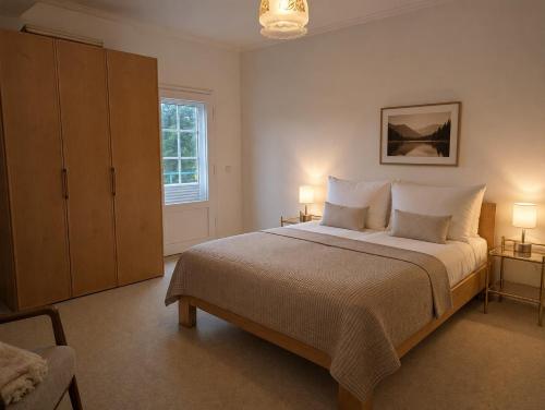 a bedroom with a large bed and two lamps at HarzHaus Hahnenklee in Hahnenklee-Bockswiese