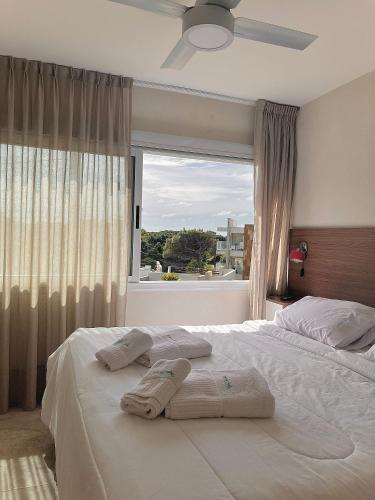 a bedroom with a large bed with towels on it at Zelena Voda in Villa Gesell
