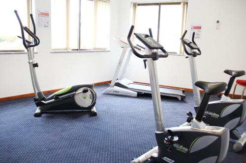 a gym with three exercise bikes in a room at Hotel Eurosol Seia Camelo in Seia