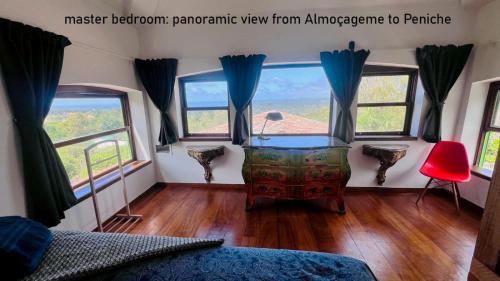 a bedroom with a bed and a room with windows at Myhomereservation Flores Daqui Lodge Colares Sintra in Colares