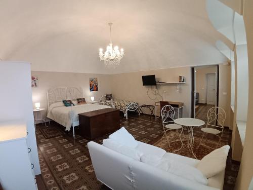 a living room with a bed and a couch at La Corte della Musica in Roppolo
