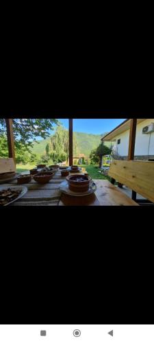 a view of a table with plates of food on it at ILIS House Matka Canyon - 2 in Skopje