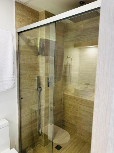 a shower with a glass door in a bathroom at 2201 Hermoso apartamento poblado in Medellín