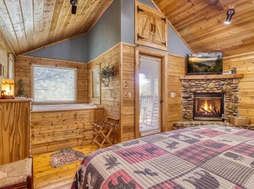 a log cabin bedroom with a fireplace and a bed at Precious Moments in Sevierville