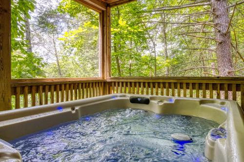 a hot tub in a porch with a window at Precious Moments in Sevierville