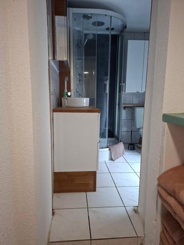 a bathroom with a sink and a mirror at La Maison du Cordonnier in Fréland