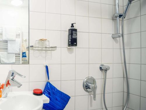 a bathroom with a shower with a sink and a toilet at ibis budget Berlin Alexanderplatz in Berlin