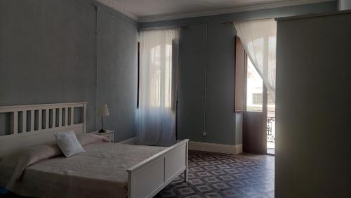 a bedroom with a bed and a large window at Sa Bonora in Iglesias