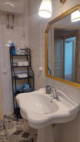 a bathroom with a sink and a mirror at Sa Bonora in Iglesias