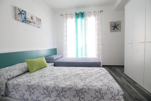 a small bedroom with a bed and a window at Appartamenti LE TRE ISOLE - Perla in San Vito lo Capo