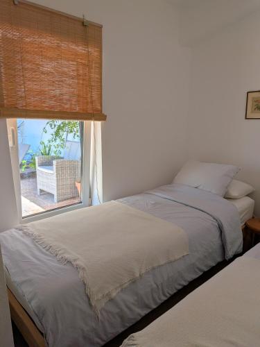a bedroom with a bed and a large window at River Ebro Apartments in Móra d'Ebre