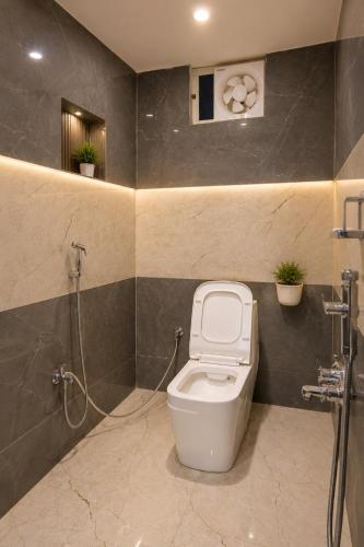 a bathroom with a toilet and a shower at Vibhor peace cottage in Chitrakoot