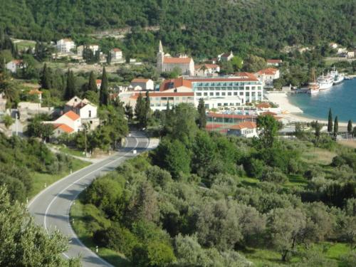 a winding road in a town next to the water at Guest House Pavkovic in Slano