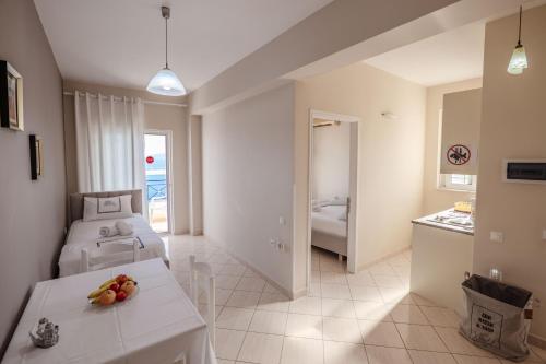 a bedroom with two beds and a table with fruit on it at Elidon Apartments in Sarandë