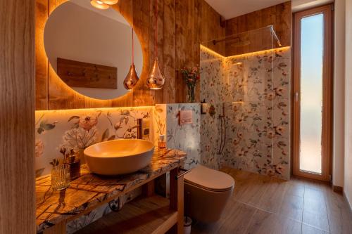 a bathroom with a sink and a mirror at CHATY U HARREGO NAD STAWEM SPA sauna, balia, rowery, klimatyzacja, in Kudowa-Zdrój