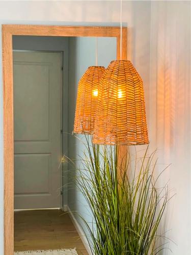 a lamp in a room with a plant and a mirror at La Cupric in Sarichioi