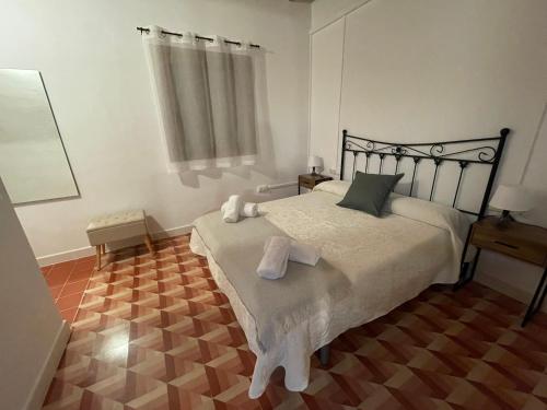 a bedroom with a bed with two towels on it at Masia La Sort in Riba-roja d'Ebre