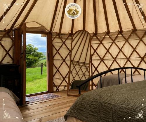 an interior of a yurt with a bed and a window at Edinburgh Festival Glamping By Stay Social Stays in Edinburgh
