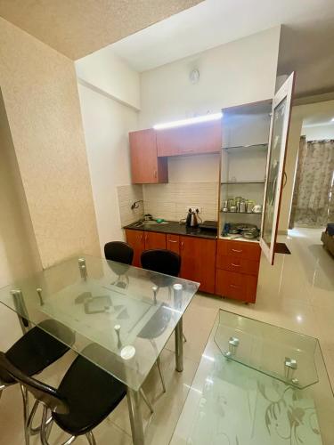 a kitchen with a table and chairs in a room at ZenRoofs - Brij Bhumi Haven 1 in Vrindāvan