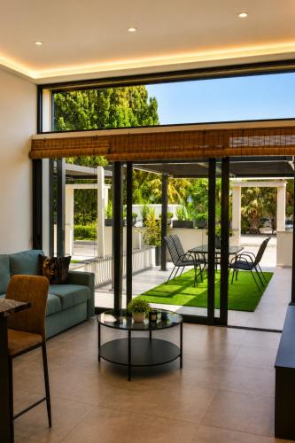 a living room with a couch and a table at Allure Suites in Larnaca