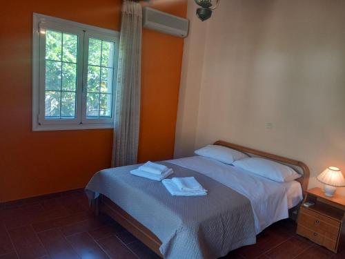 a bedroom with a bed with towels on it at Mytikas villa in Kandíla