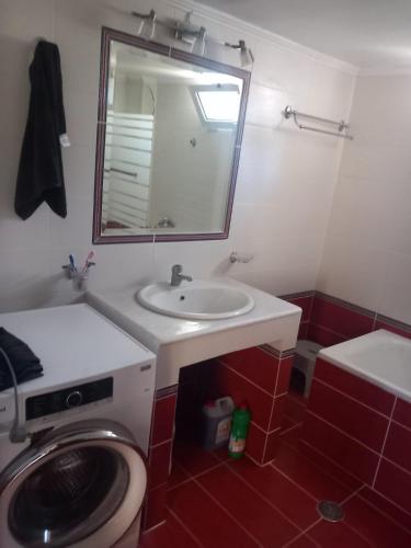 a bathroom with a washing machine and a sink at Mytikas villa in Kandíla
