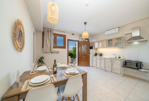 a kitchen and dining room with a table and chairs at Tassos Cottage Fiskardo in Fiskardo