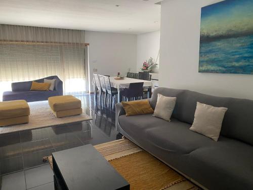 a living room with a couch and a dining room at Casa do Vale Vintém in Condeixa a Nova