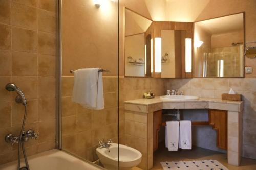 a bathroom with a shower and a tub and a sink at La Villa Mandarine in Rabat