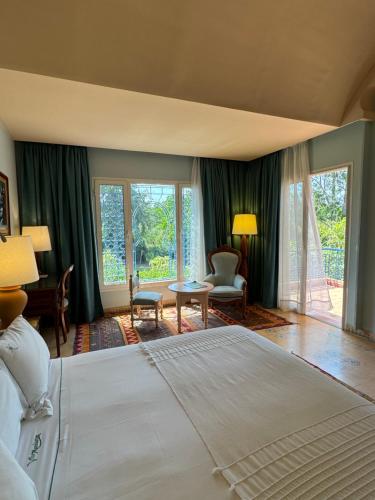 a bedroom with a large bed and a living room at La Villa Mandarine in Rabat