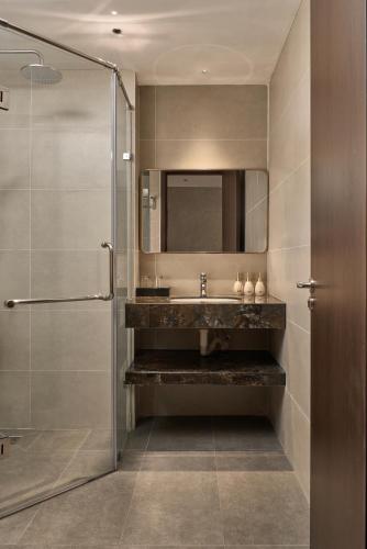 a bathroom with a sink and a mirror at Duyên Hùng Premier Hotel in Diện Biên Phủ