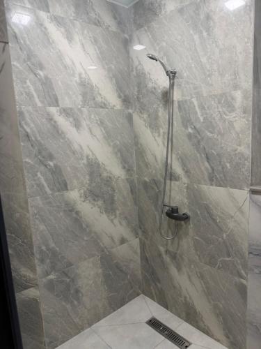 a bathroom with a shower with a glass door at Fantastico 270 in Batumi