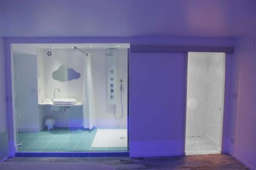 a purple bathroom with a shower and a sink at L'inattendu in Les Piards