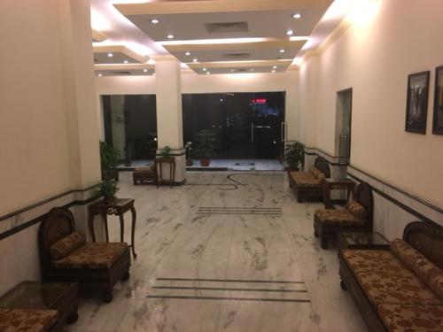 a lobby with couches and chairs in a building at Shiva Oasis Resort in Neemrana