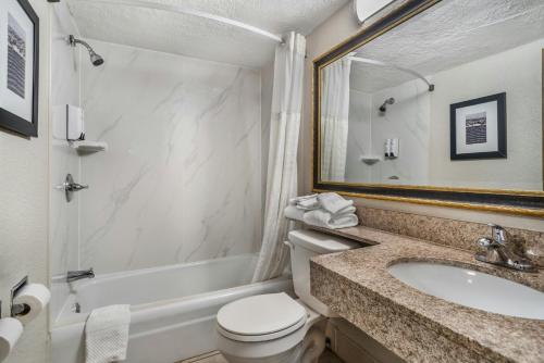 a bathroom with a sink and a toilet and a tub at Red Roof Inn Gastonia in Gastonia