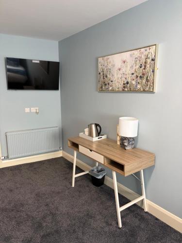 a room with a table and a painting on the wall at The Pod on John St in Wexford