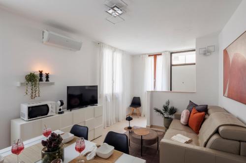a living room with a couch and a table at Brezza della Fortuna in Fano