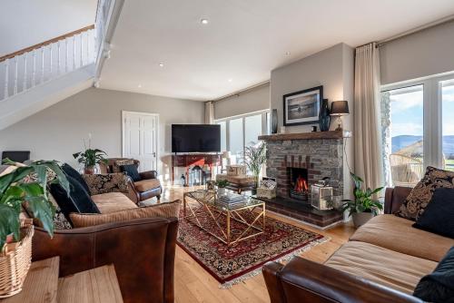 a living room with couches and a fireplace at The Iveragh in Kenmare