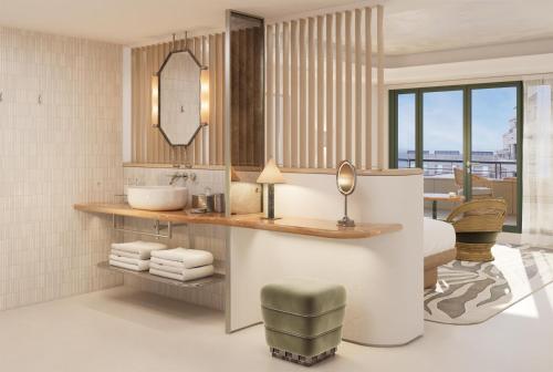 a bathroom with a sink and a mirror at Hotel Palais de la Mediterranee, in the Unbound Collection by Hyatt in Nice