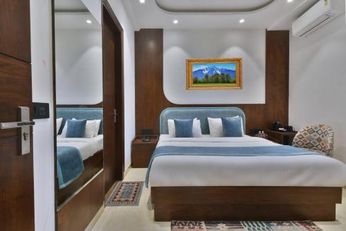 a hotel room with two beds and a doorway at Hotel Namaskar India - Just A Minute Away From New Delhi Railway Station & Connaught Place in New Delhi