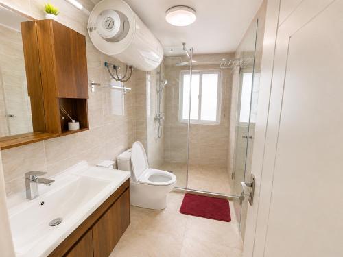 a bathroom with a toilet and a sink and a shower at Residential Capital Plus in Accra
