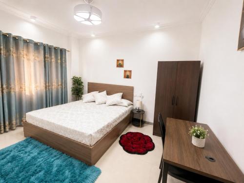 a bedroom with a bed with a blue rug at Residential Capital Plus in Accra