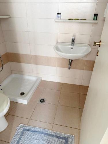 a bathroom with a sink and a toilet at Argo Rooms Antiparos in Antiparos