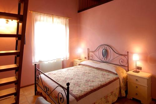 Agriturismo Verziere في Fermignano: غرفة نوم بها سرير ونافذة